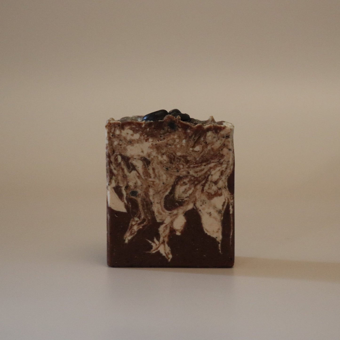 Bar of soap with a textured surface on a beige background