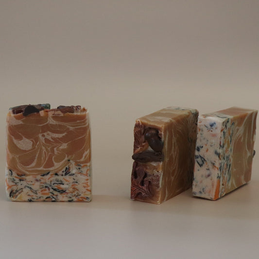 Three marbled soap bars on a plain background