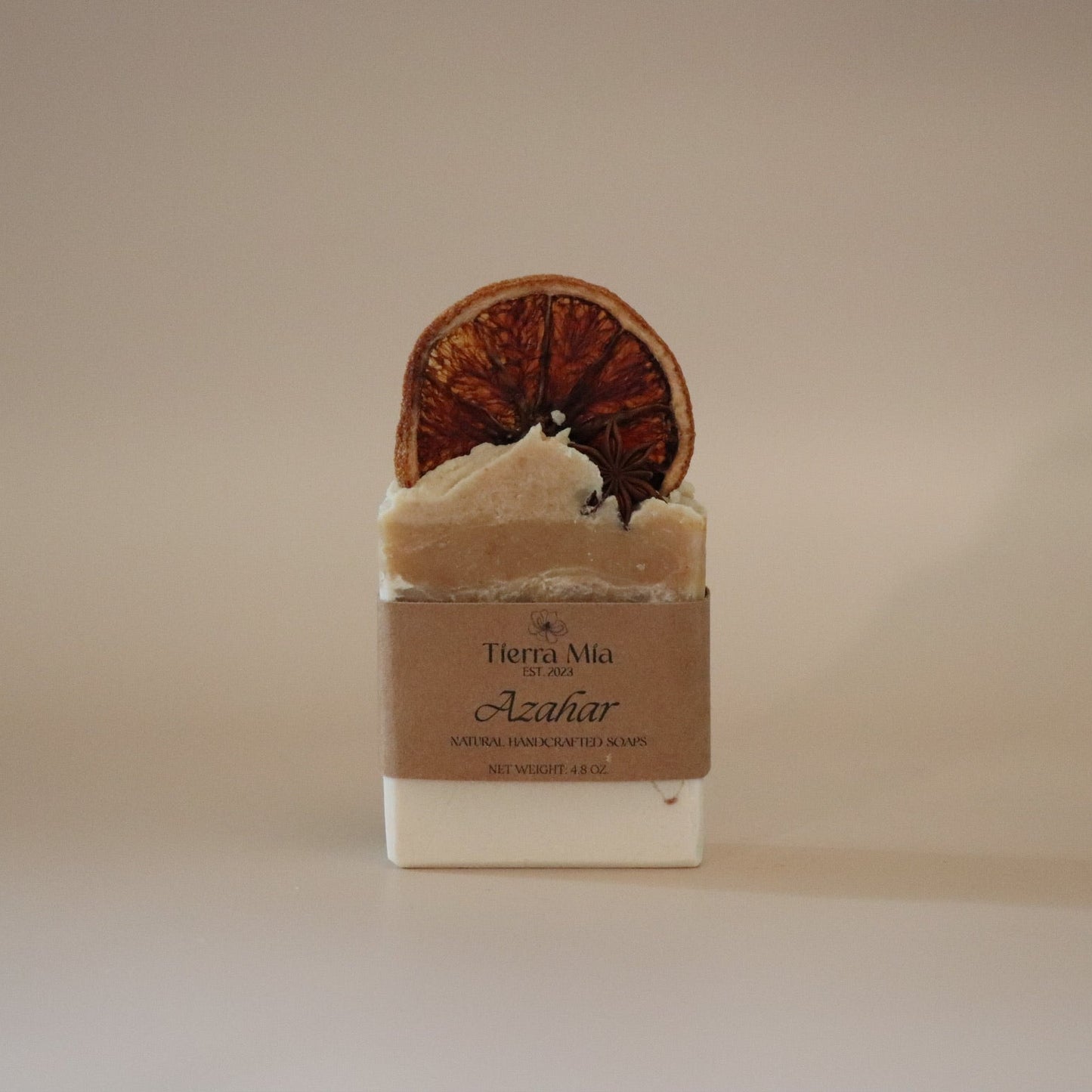 Bar of soap with a decorative top on a beige background