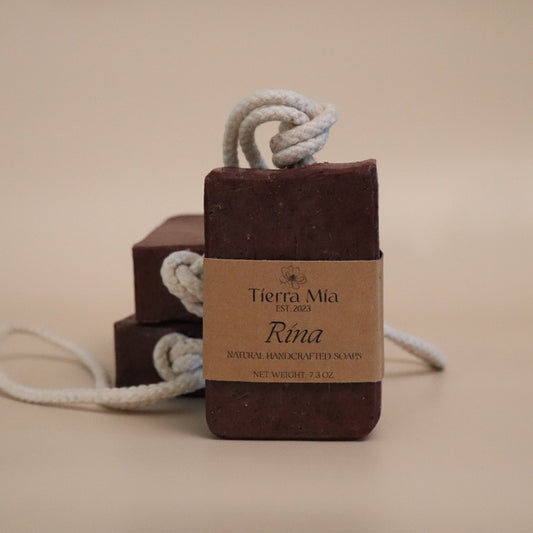 Dark red soap with a rope and 'Tierra Mia' label on a beige background
