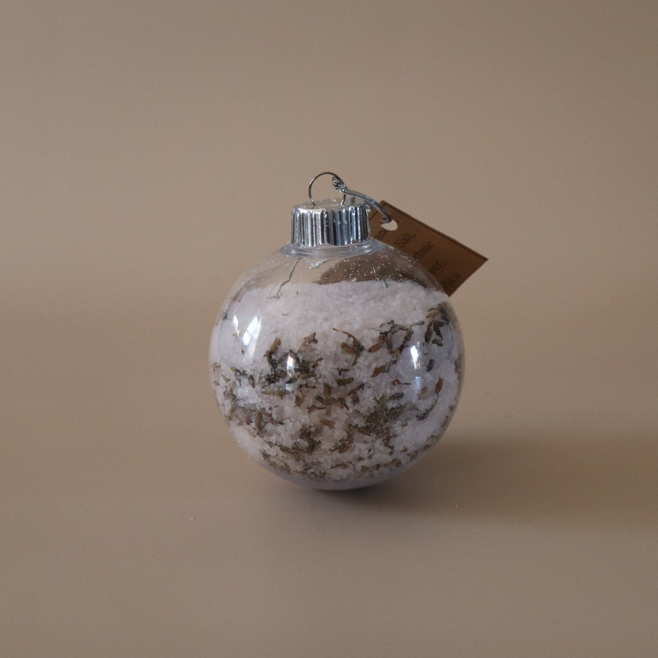 Decorative ornament with a brown tag on a beige background