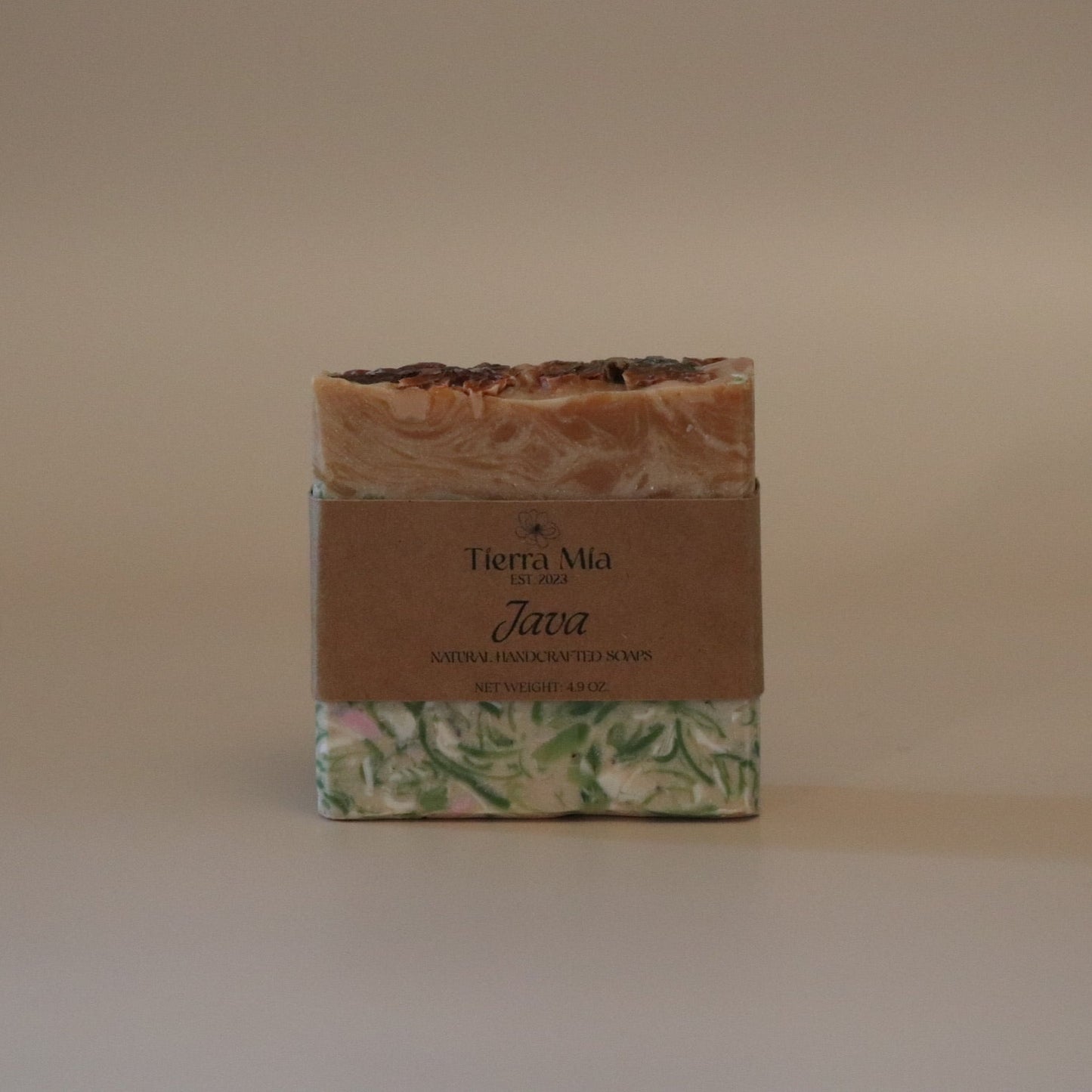 Bar of soap with a decorative label on a beige background