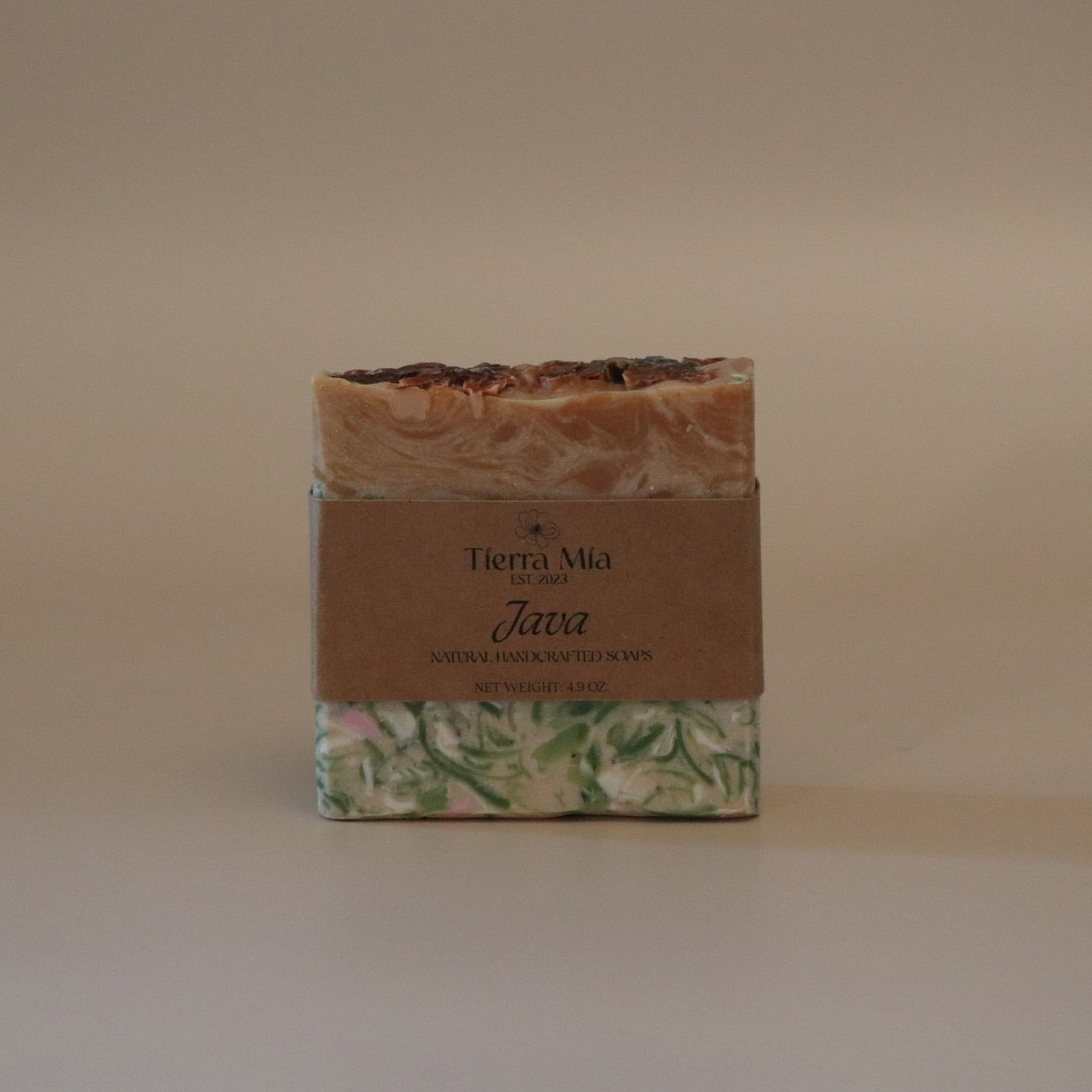 Bar of soap with a decorative label on a beige background