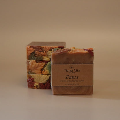 Four soap bars with leaf patterns on a beige background