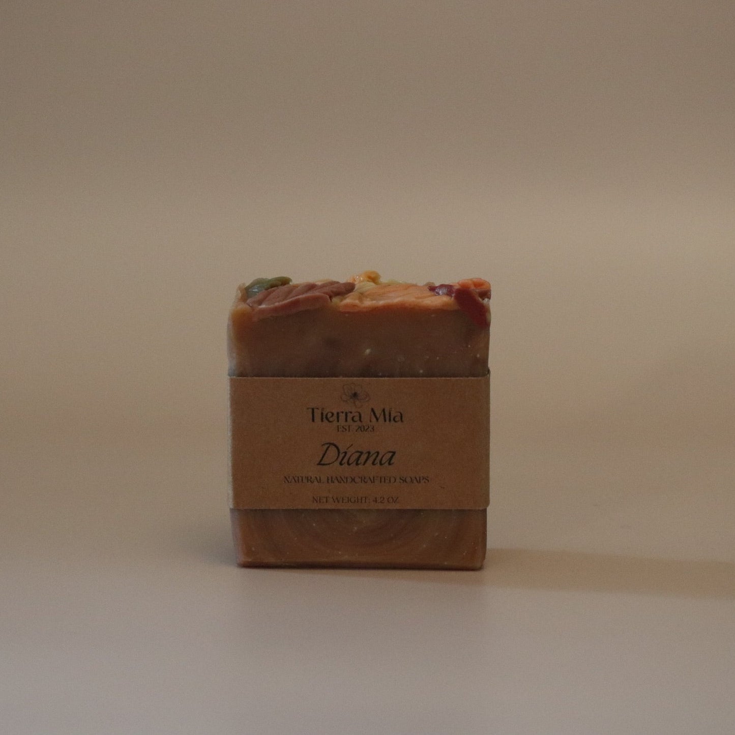 Bar of soap with a label on a beige background