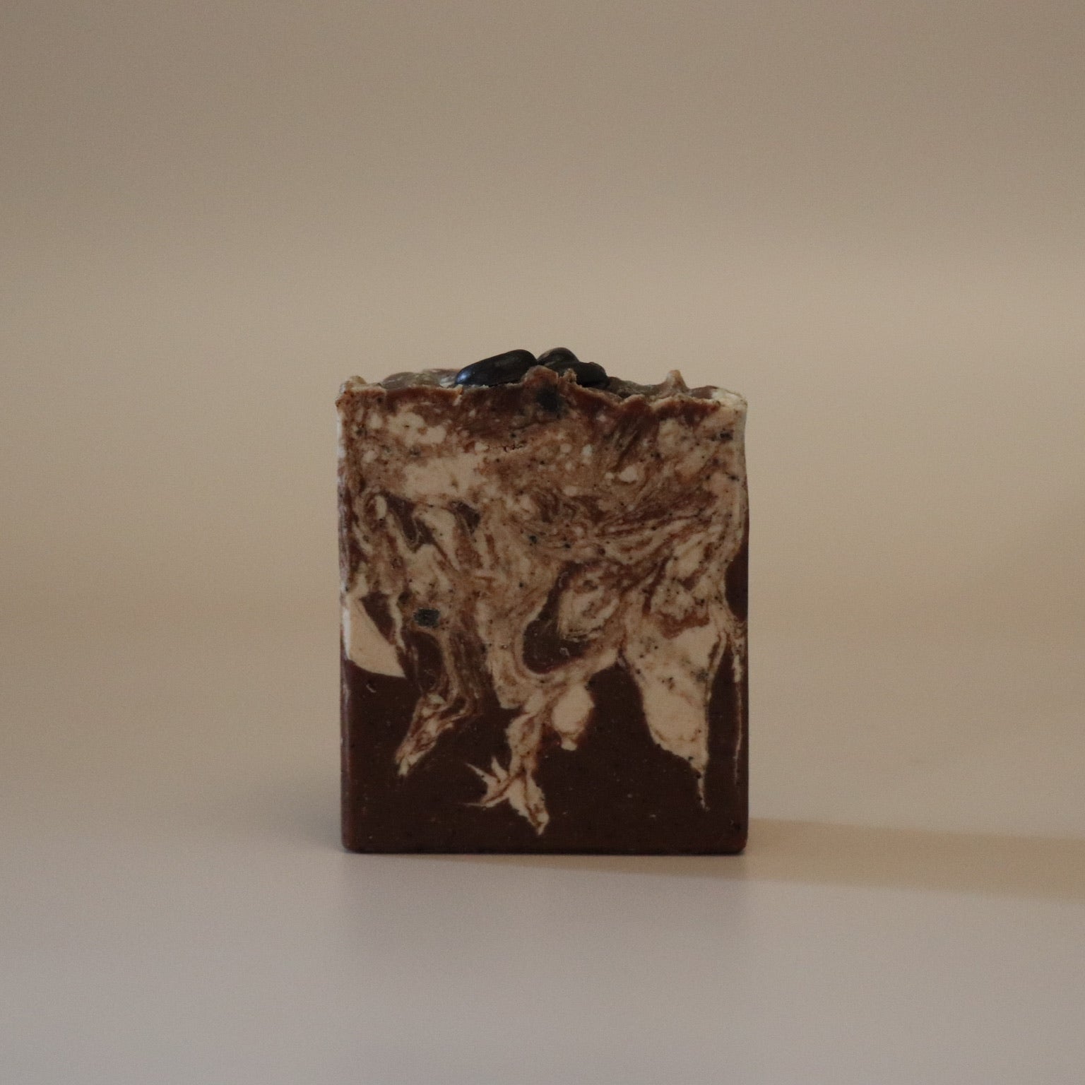 Bar of soap with a textured surface on a beige background