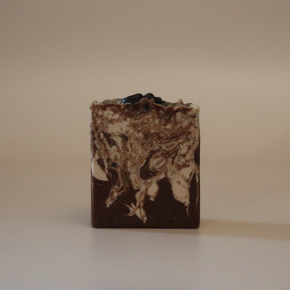 Bar of soap with a textured surface on a beige background
