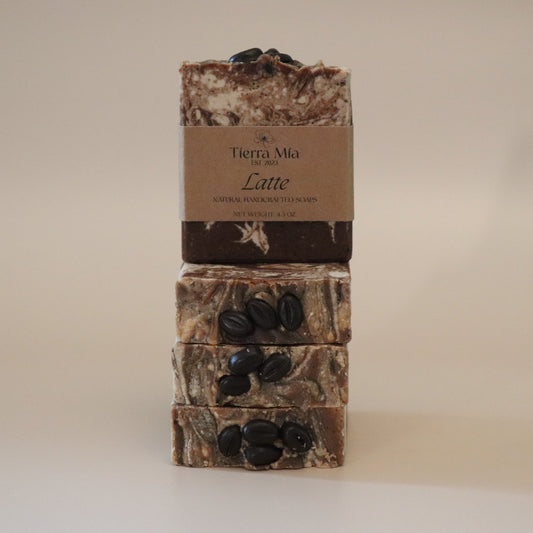 Three stacked soap bars with a brown label on a beige background