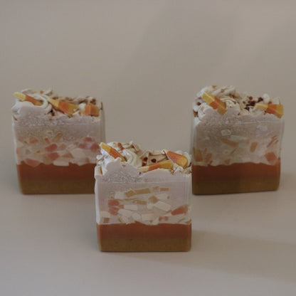 Three layered soap bars with visible layers on a plain background
