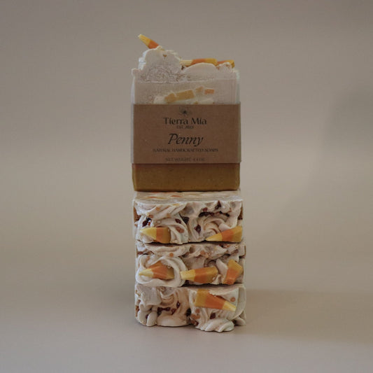Stack of soap bars with a brown labeled 'Tierra Mia' on a beige background