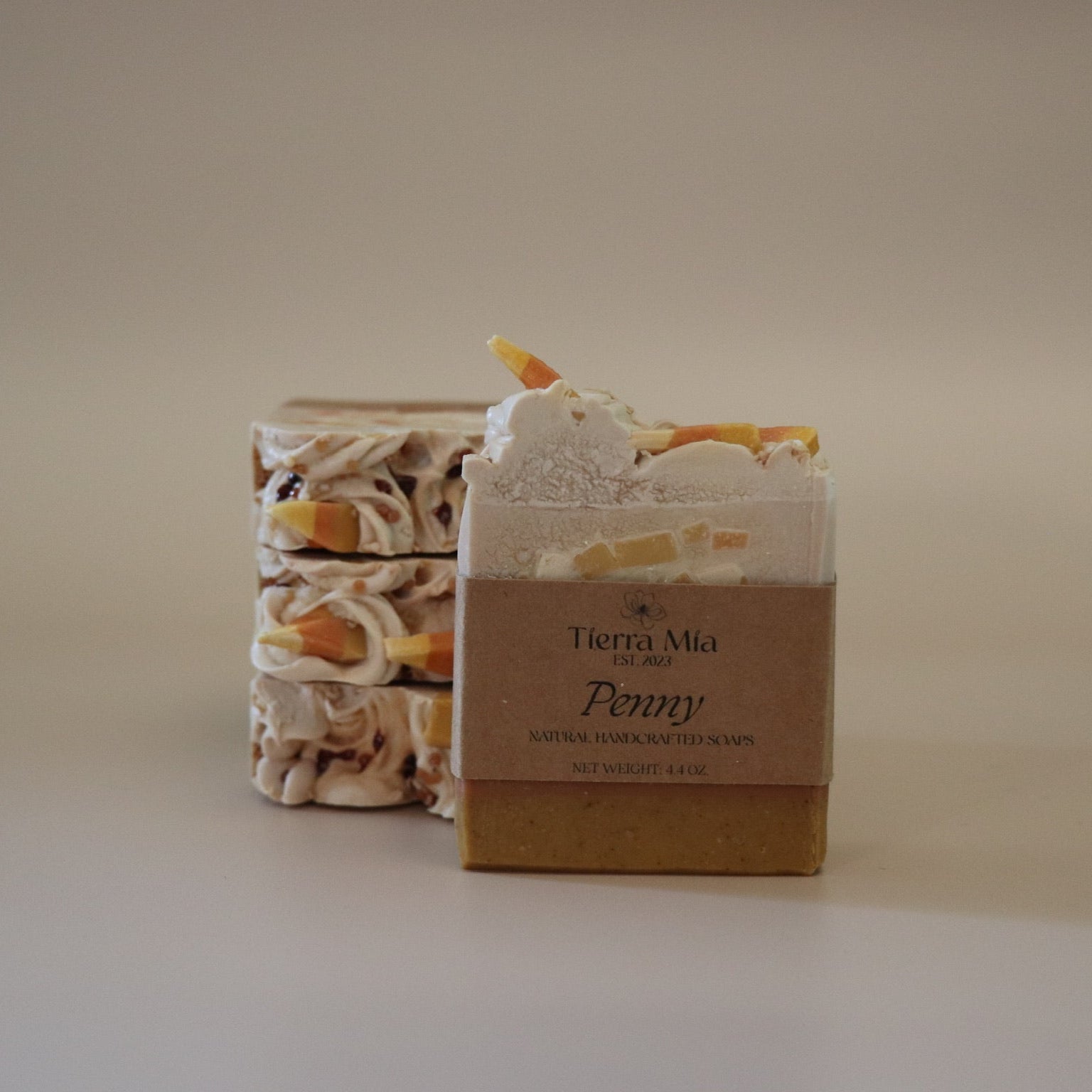 Two soap bars with decorative elements on a beige background