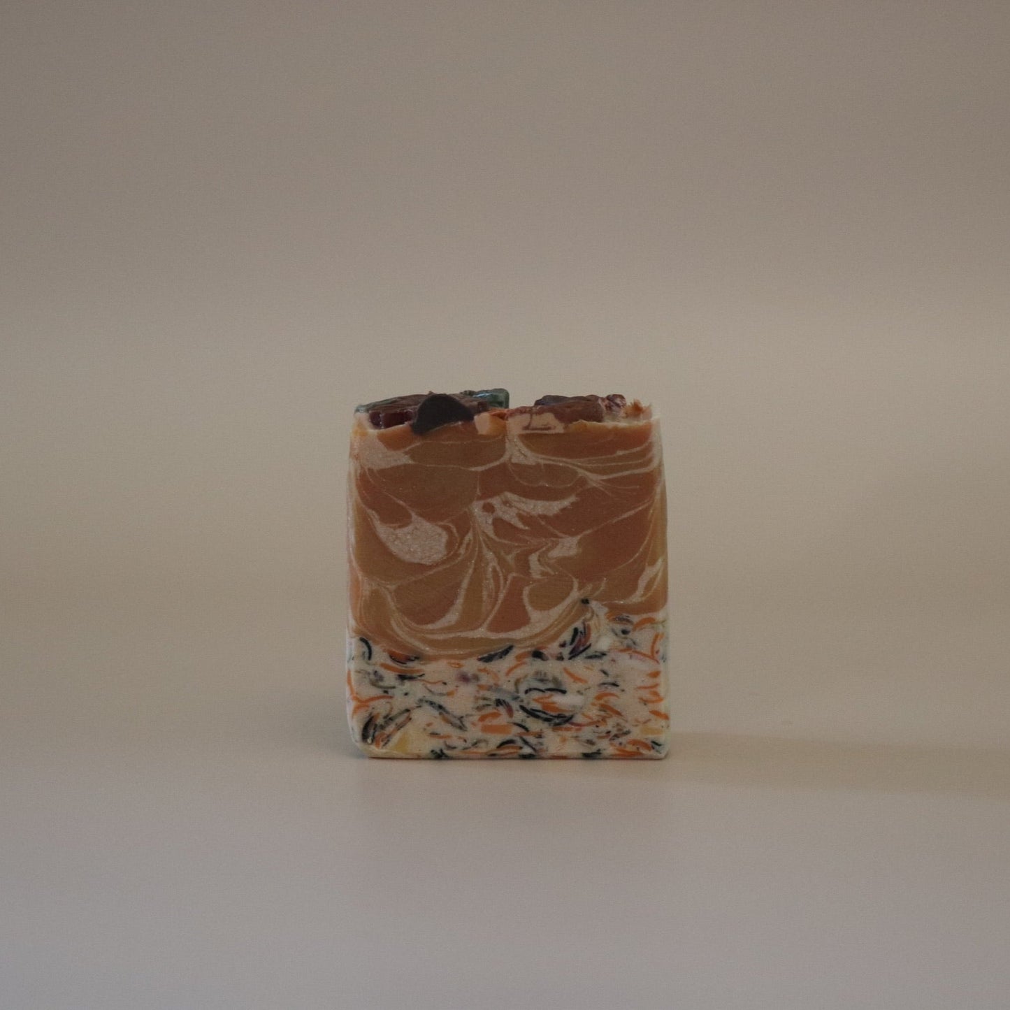 Bar of soap with a marbled pattern on a plain background