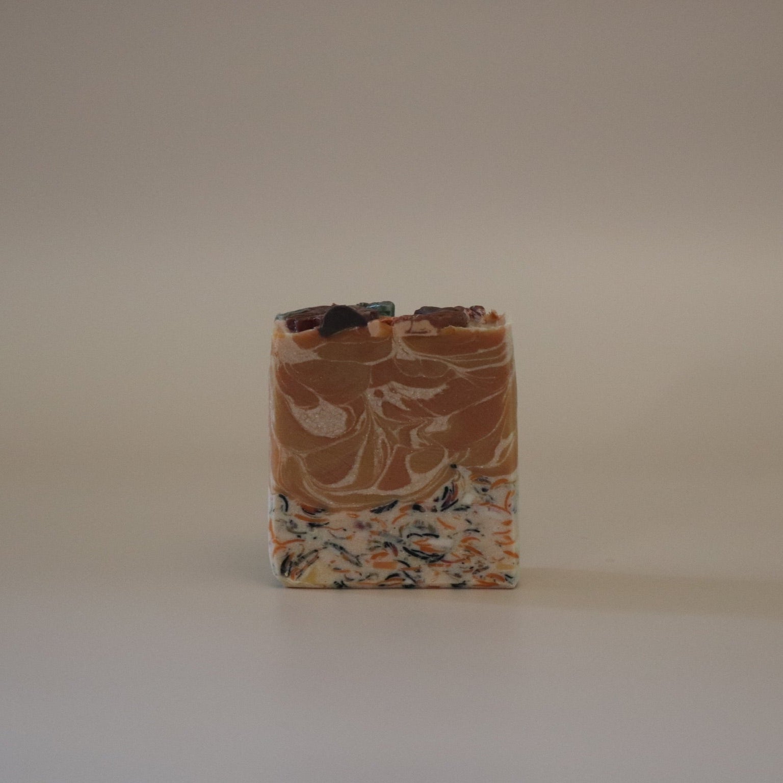Bar of soap with a marbled pattern on a plain background