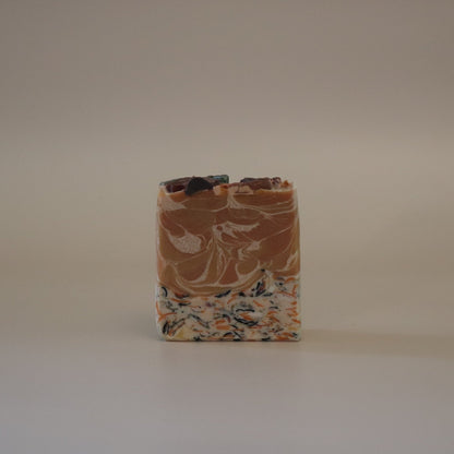 Bar of soap with a marbled pattern on a plain background