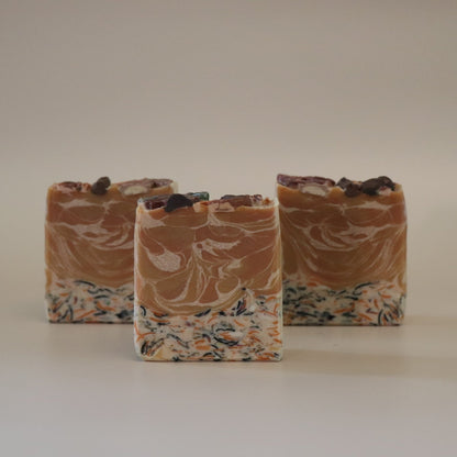 Three swirled soap bars on a plain background