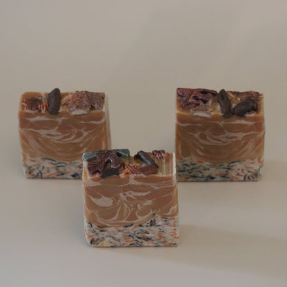 Three bars of soap with a marbled pattern on a plain background