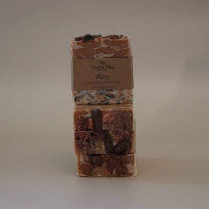 Three stacked soap bars with a label on a beige background