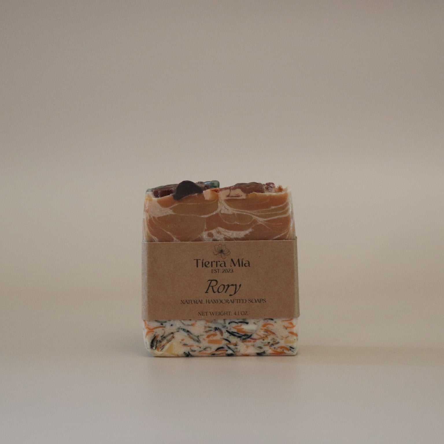 Bar of soap with a decorative packaging label on a plain background