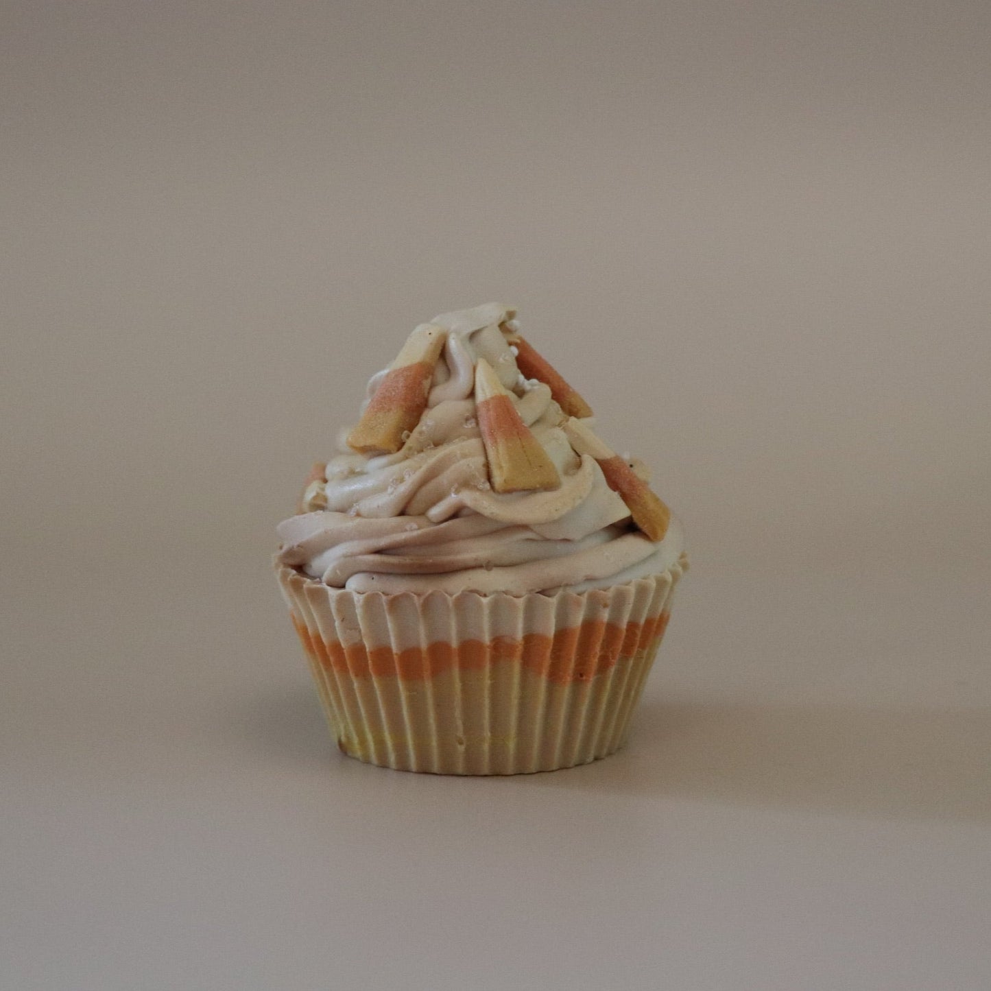 Cupcake soap bar with decorative elements on a plain background