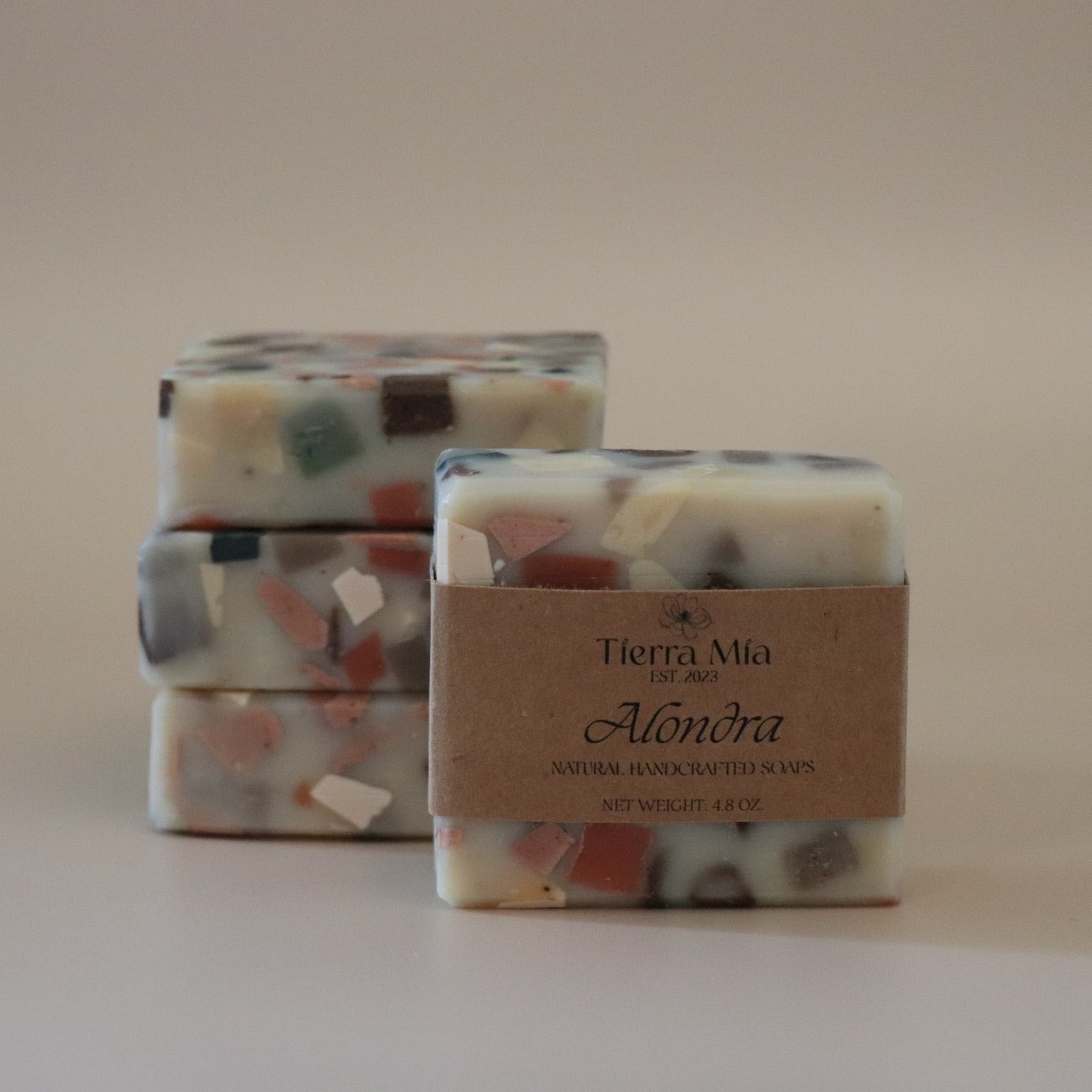 Three stacked soap bars with a visible label on a plain background