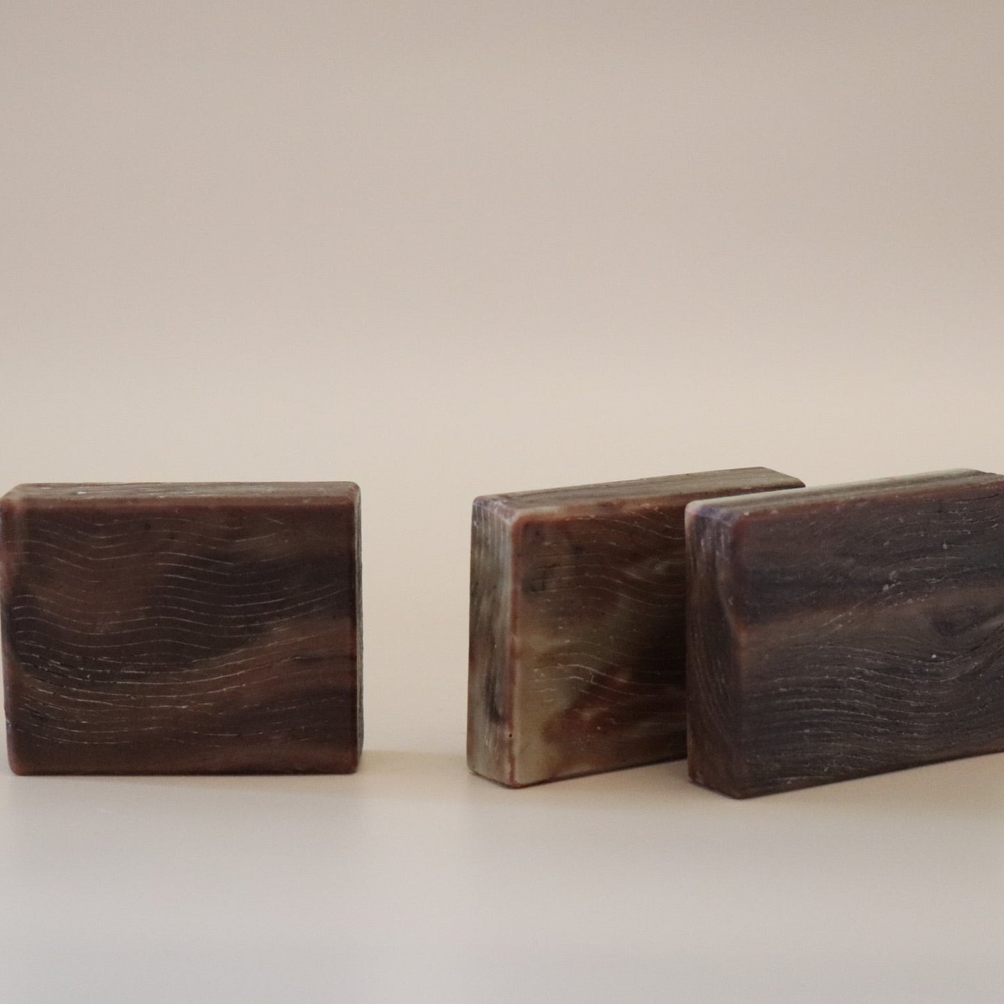 Three wooden blocks of different sizes on a beige background