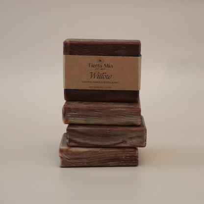 Stack of three soap bars with a label on a beige background
