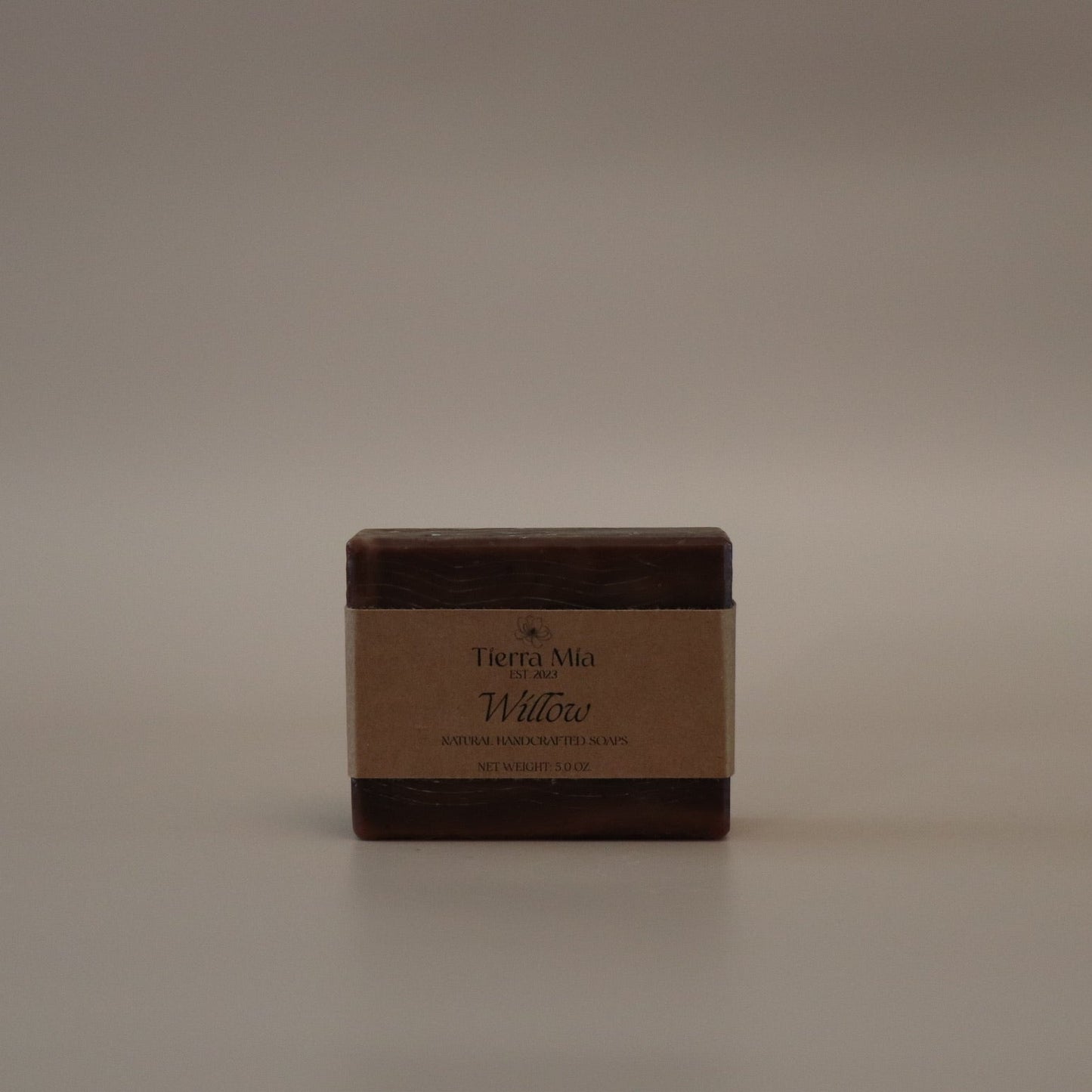 Square brown bar of soap with 'Tierra Mia' branding on a beige background