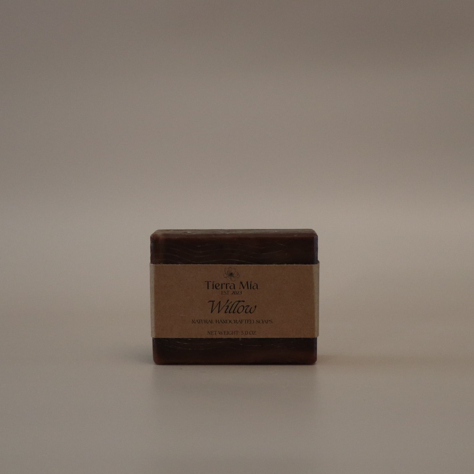 Square brown bar of soap with 'Tierra Mia' branding on a beige background