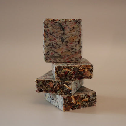 Stack of three marbled soap bars on a beige background