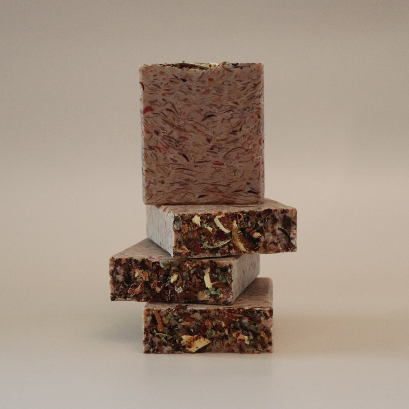 Stack of three rectangular chocolate bars on a beige background