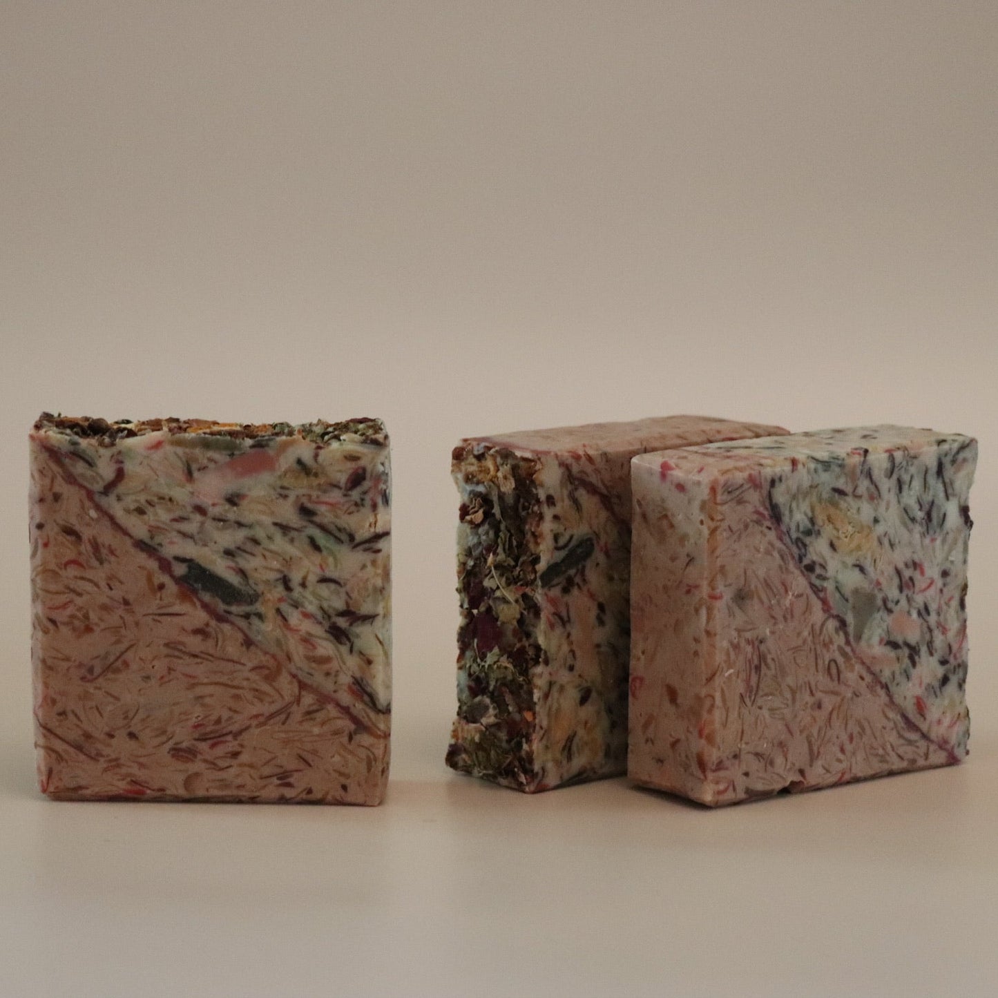 Two multicolored textured blocks on a beige background