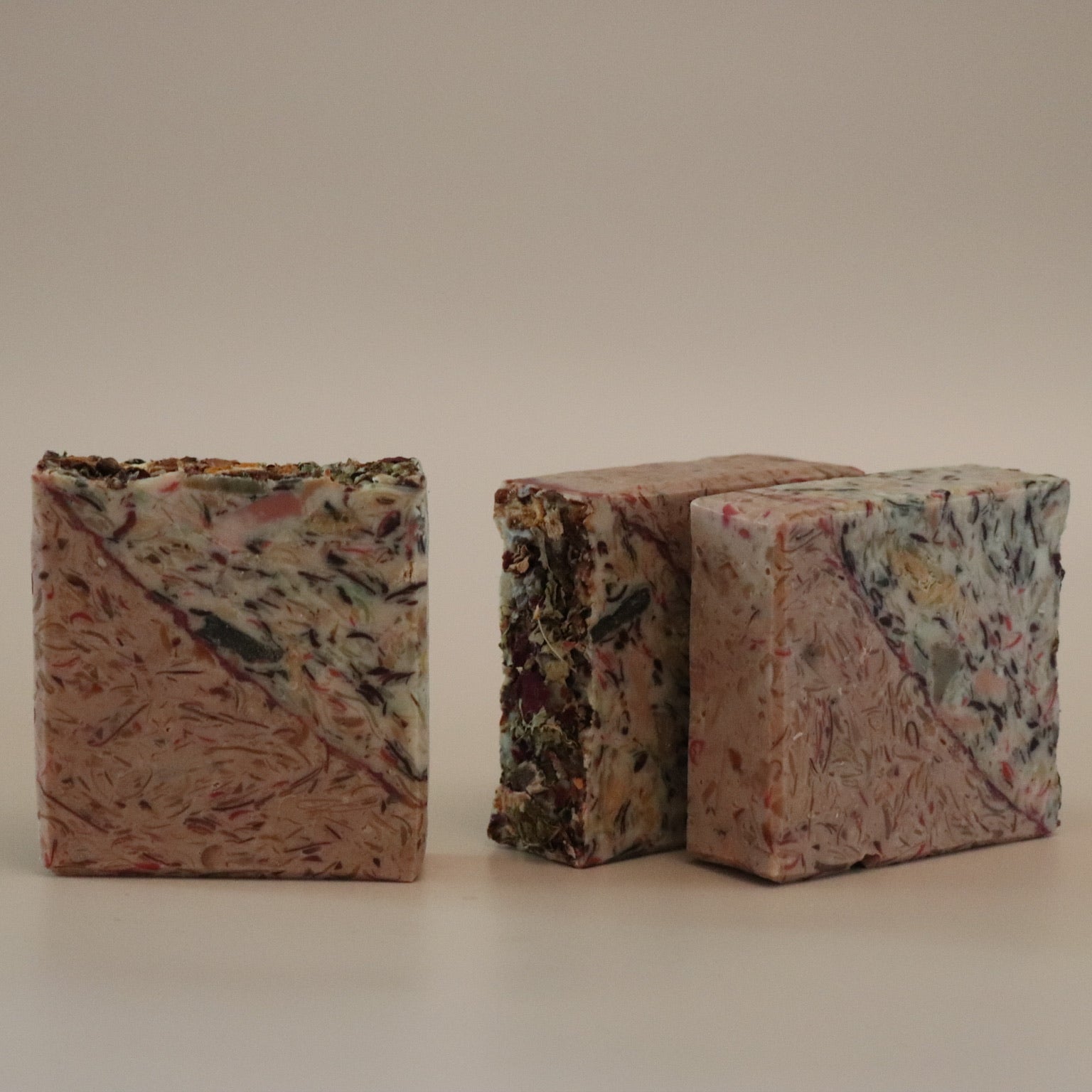 Two multicolored textured blocks on a beige background