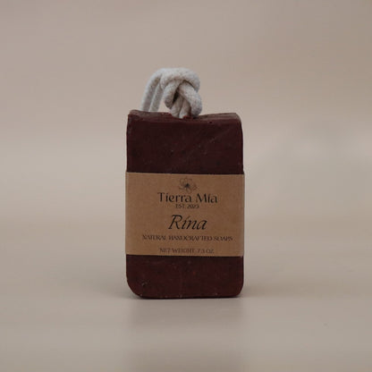 Dark Red soap bar with a rope on a beige background