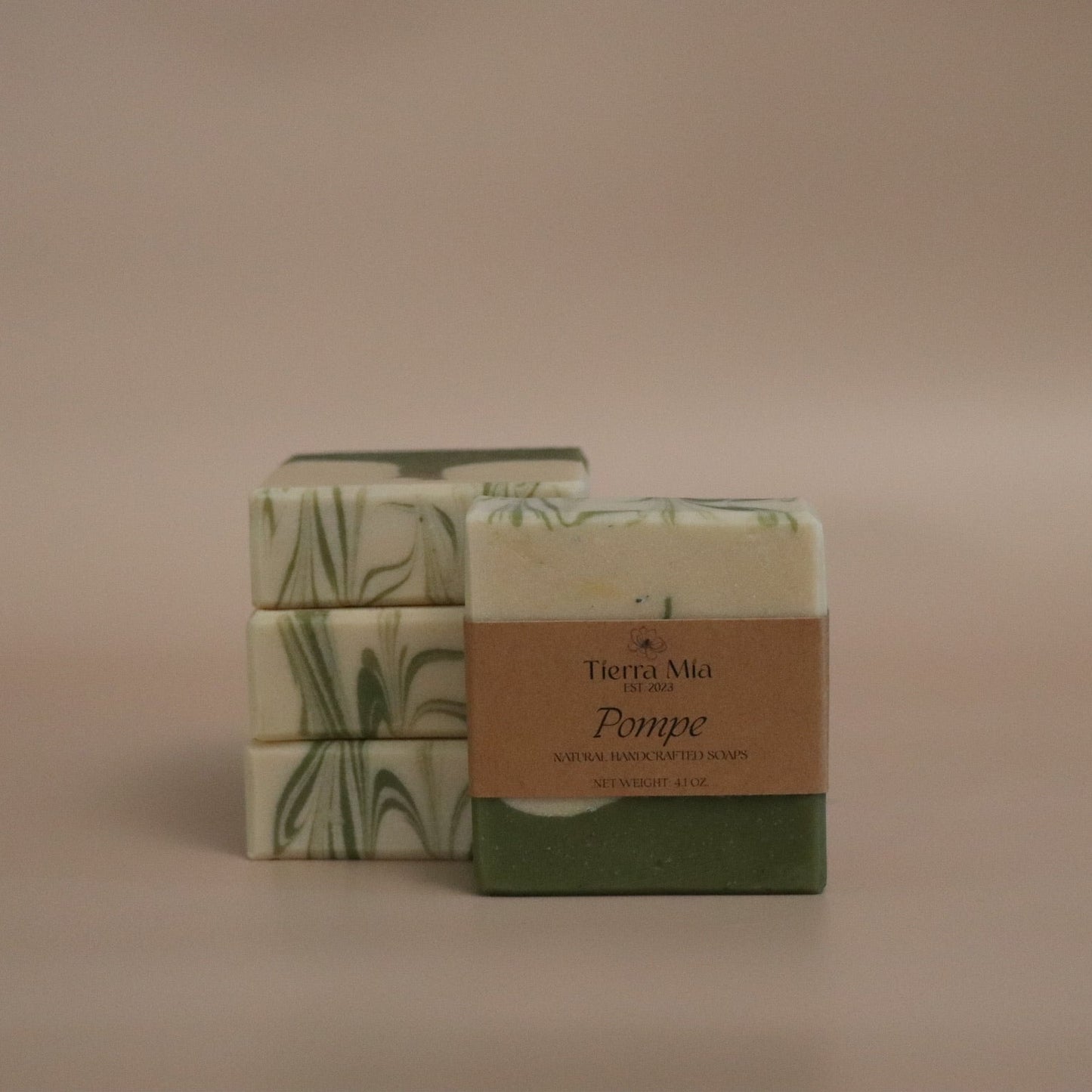 Two bars of soap with decorative packaging on a beige background