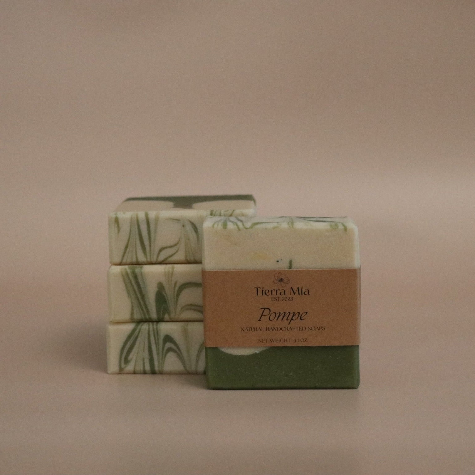 Two bars of soap with decorative packaging on a beige background