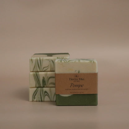 Two bars of soap with decorative packaging on a beige background