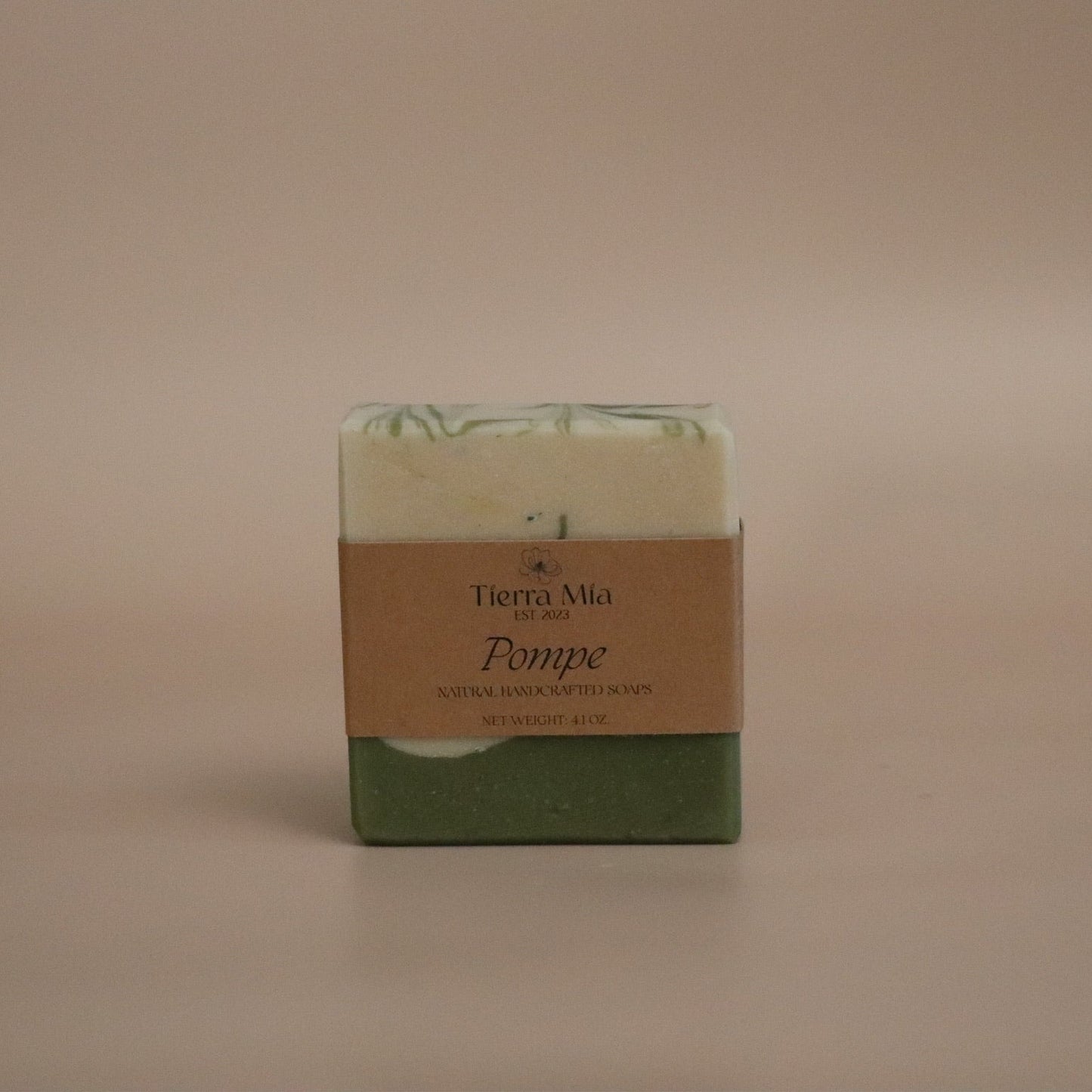 Green soap bar with a brown label on a beige background