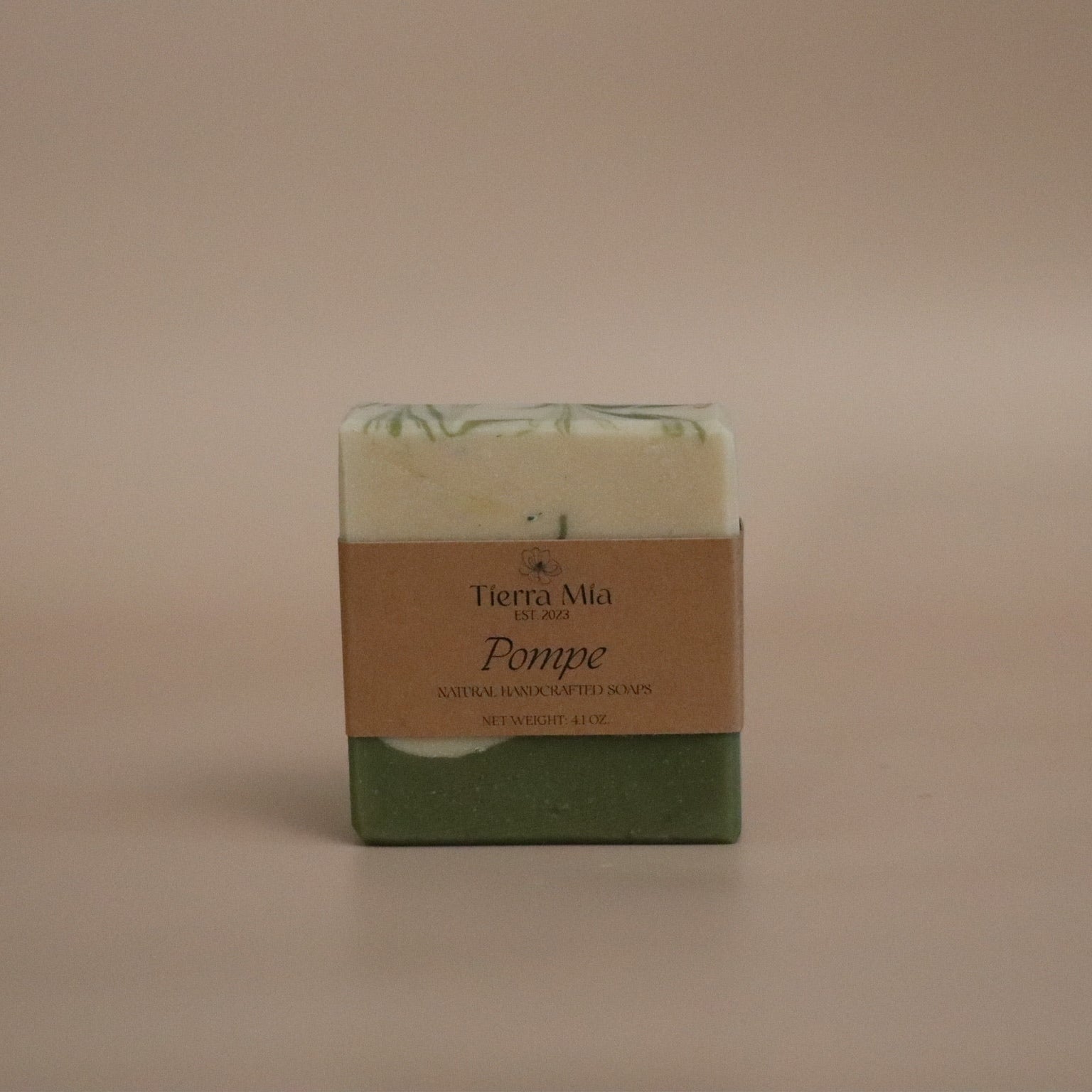 Green soap bar with a brown label on a beige background