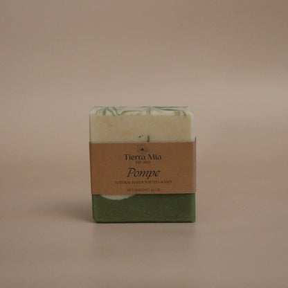 Green soap bar with a brown label on a beige background