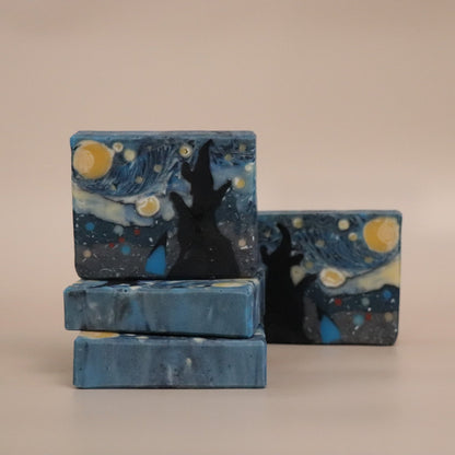 Three bars of soap with a 'Starry Night' design on a beige background