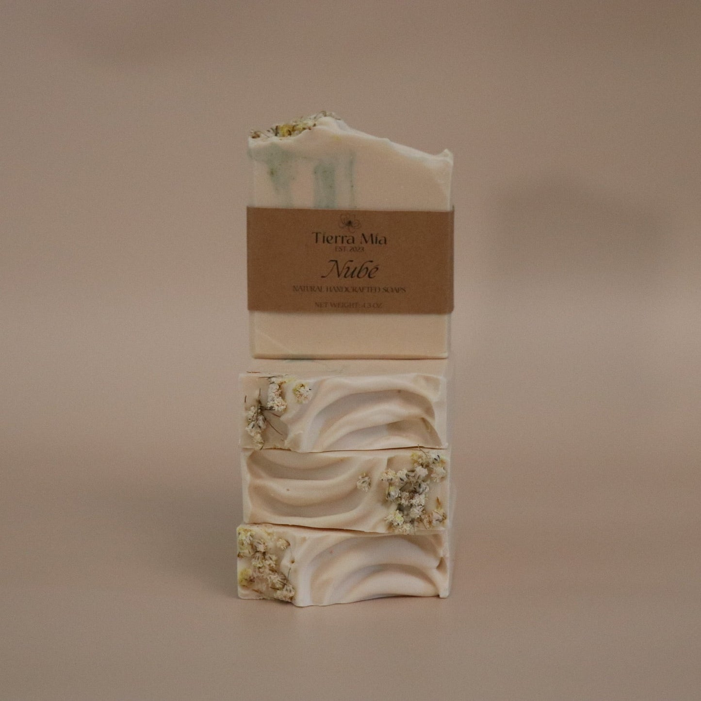 Stack of soap bars with a visible brand label on a beige background