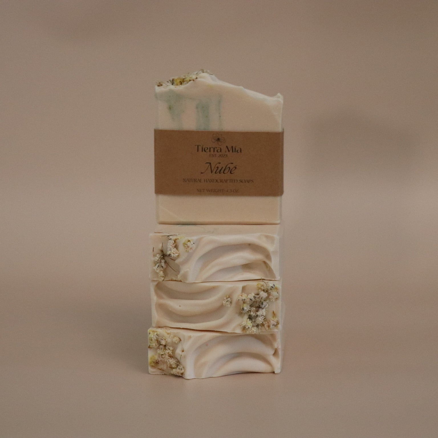 Stack of soap bars with a visible brand label on a beige background