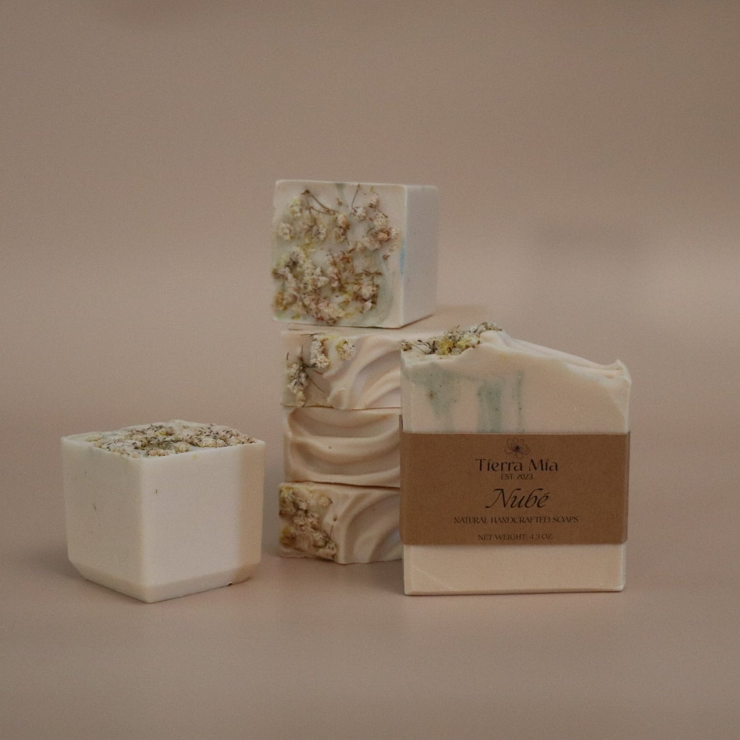 Set of soap bars with packaging on a beige background