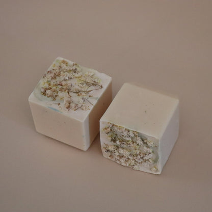 Two square blocks with floral embedded design on a beige background