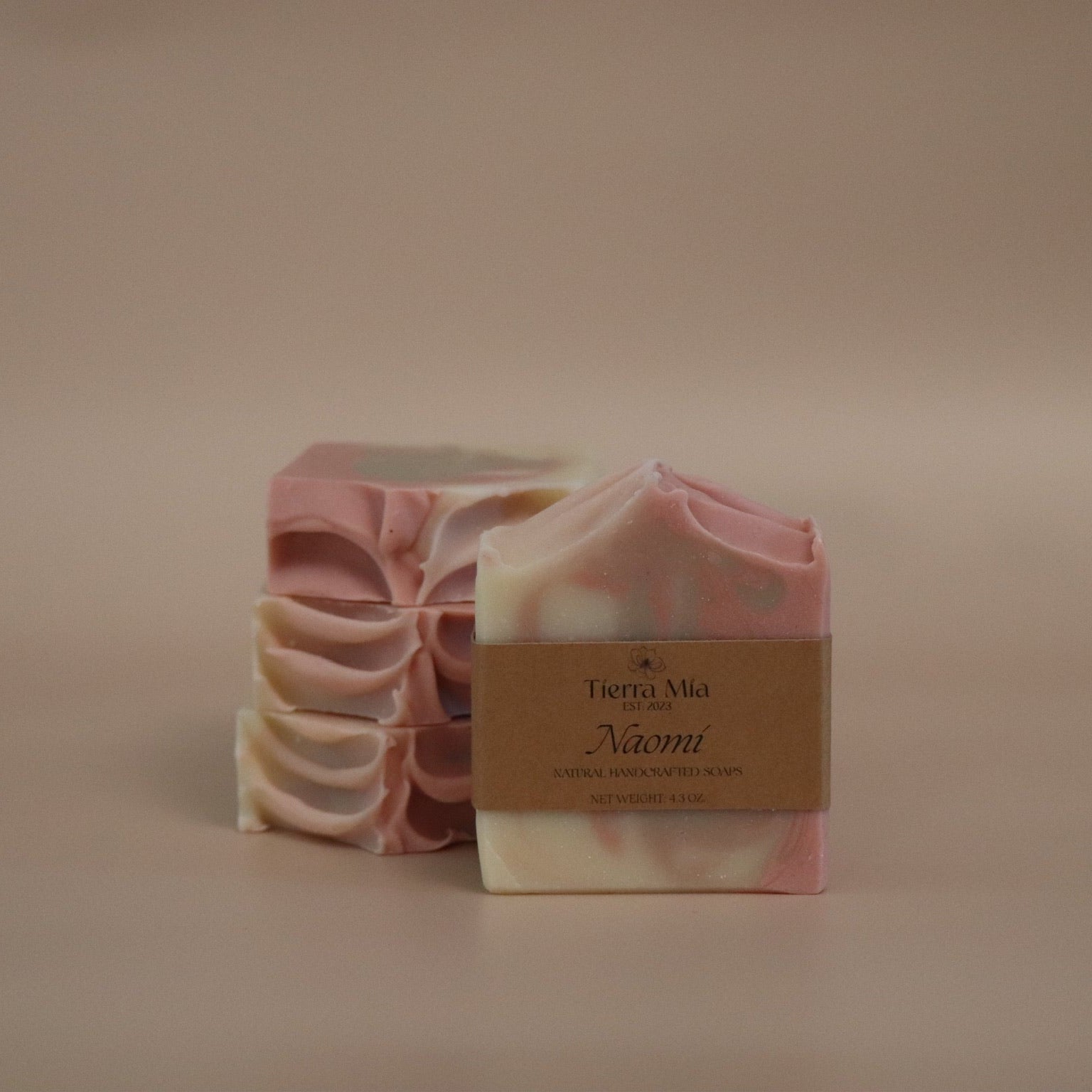 Bar of soap with a visible brand label on a beige background