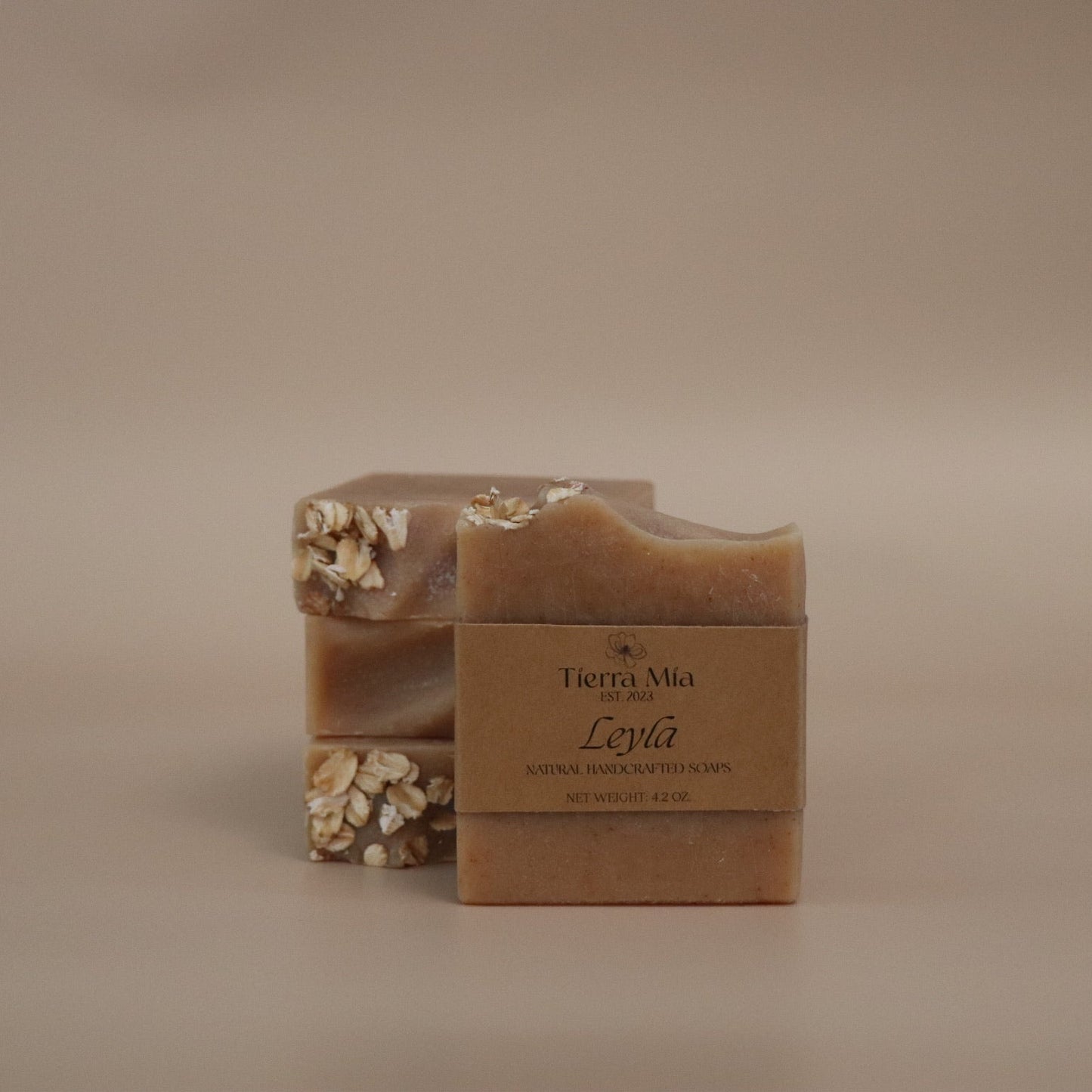 Bar of soap with a decorative top and packaging on a beige background