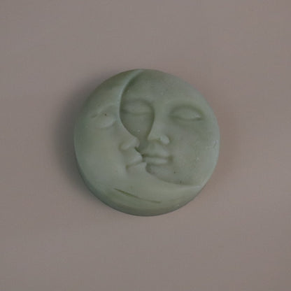 Green Moon soap with face design on a beige background