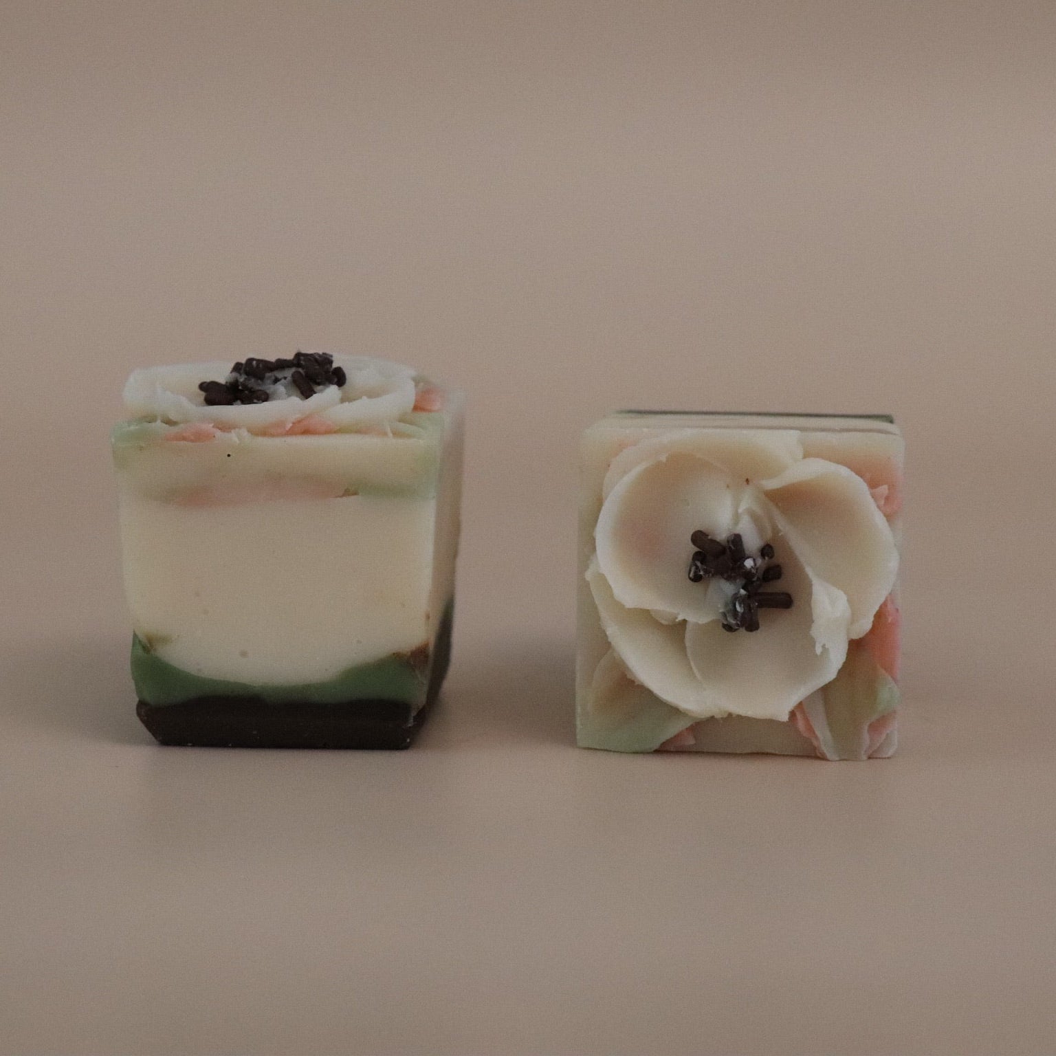 Two floral soap bars on a beige background