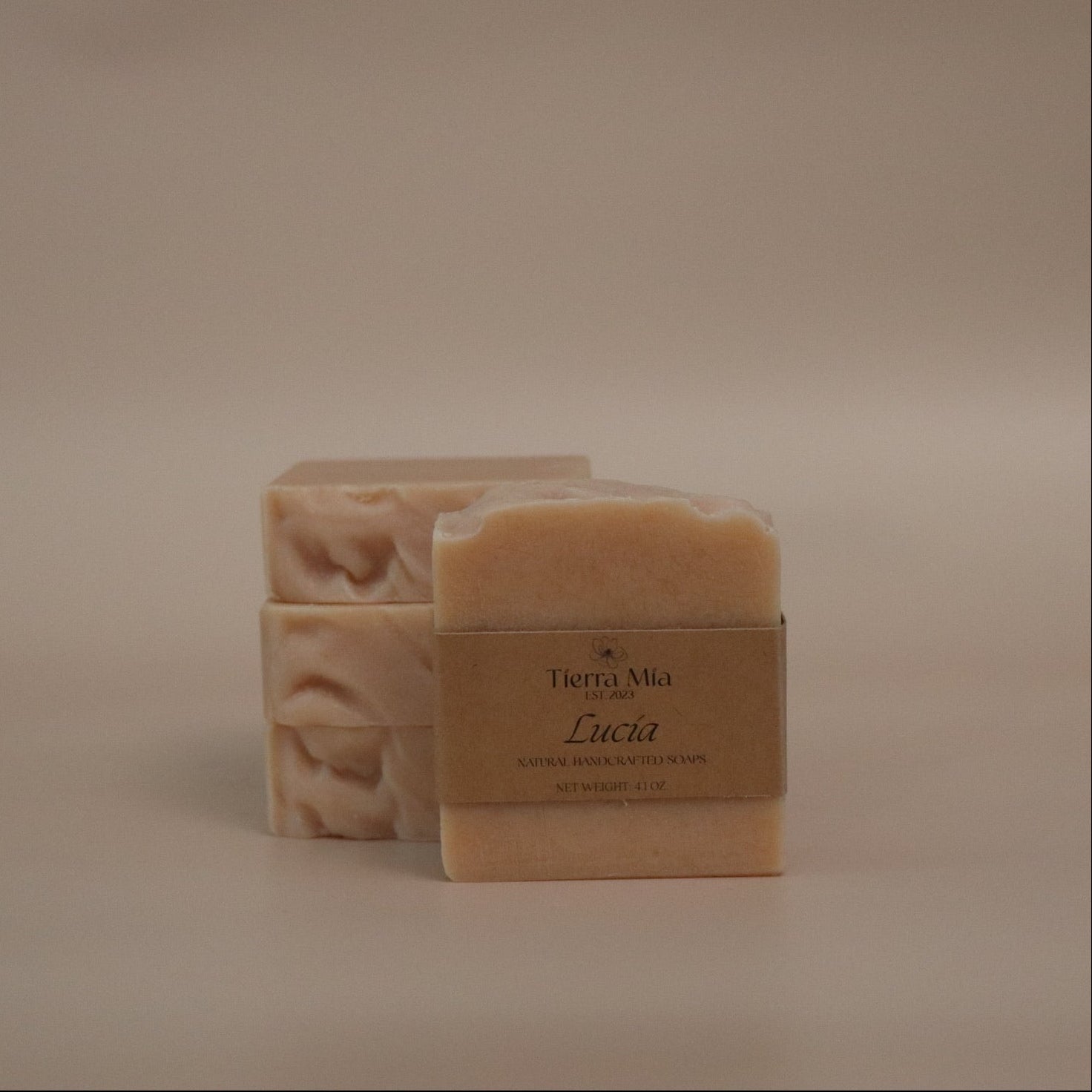 Two bars of soap with a label on a beige background