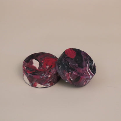 Two marbled circular objects on a beige background